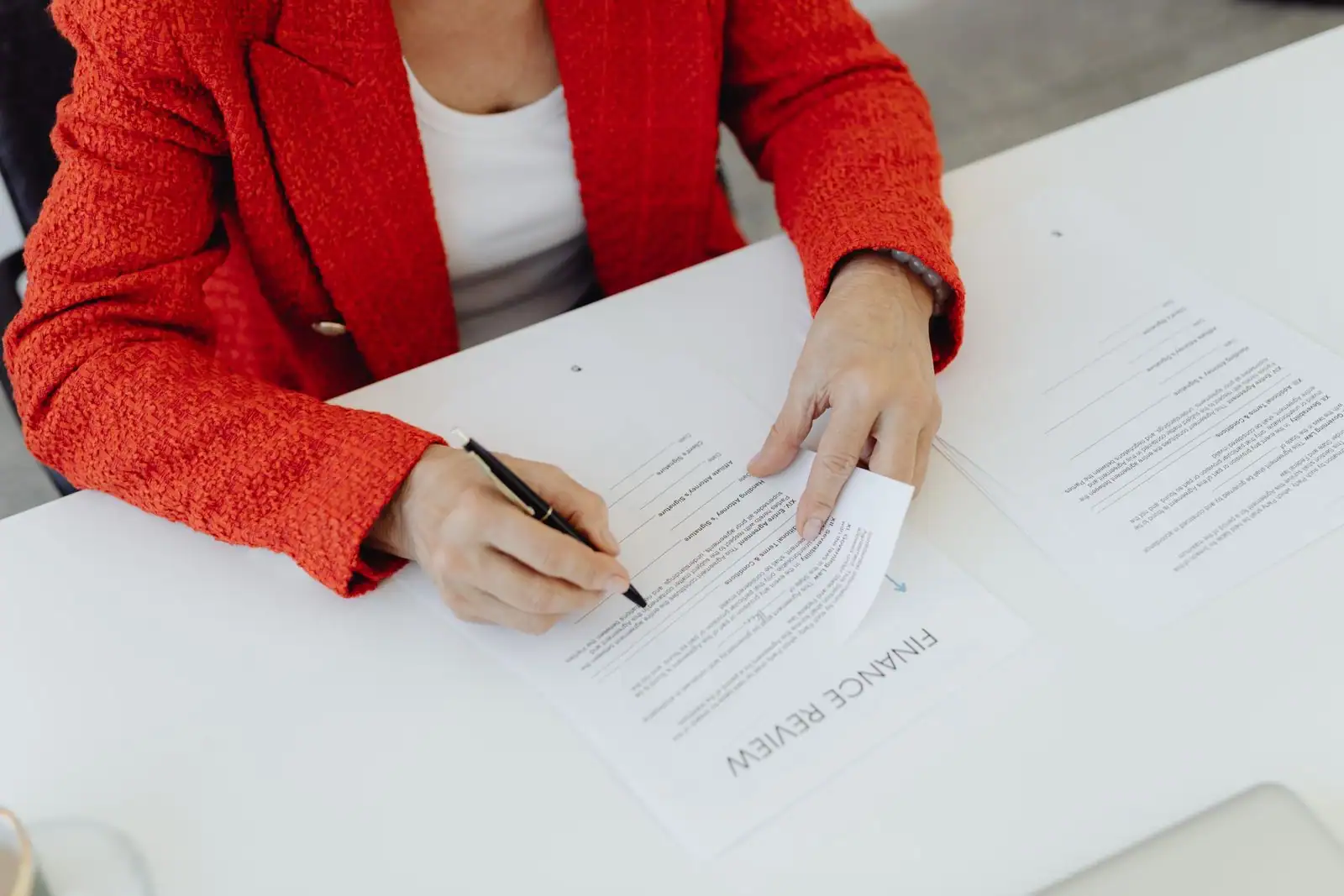 Un dirigeant d'entreprise consulte des documents financiers et un ordinateur portable à son bureau